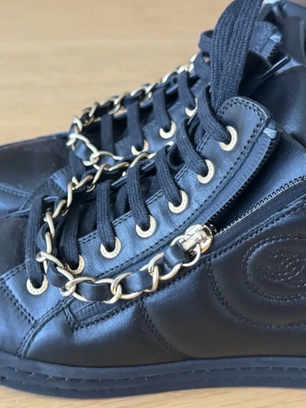 CHANEL Black Quilted High-Top Leather Sneakers with Gold Hardware